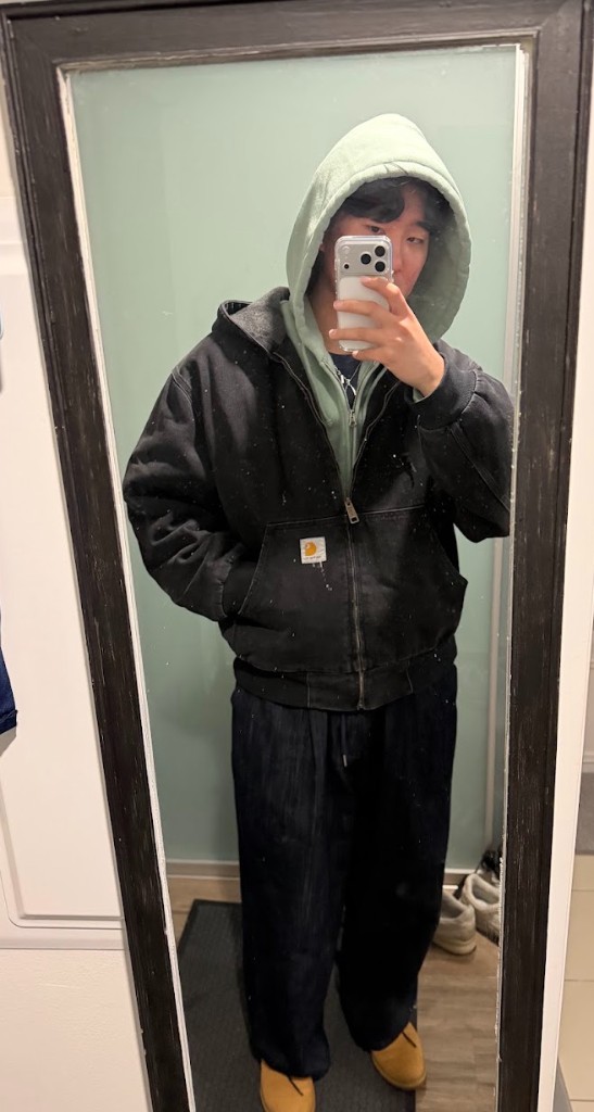 mirror selfie in a black carhartt jacket