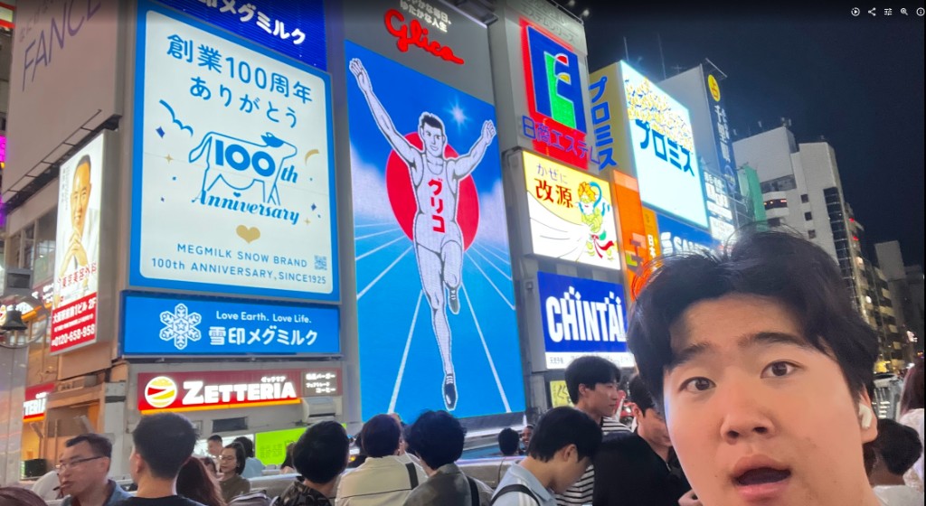 selfie in front of the glico sign in dotonbori, osaka