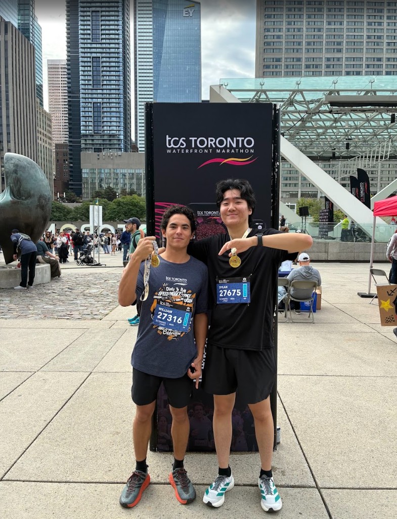 two runners with medals at the toronto waterfront marathon
