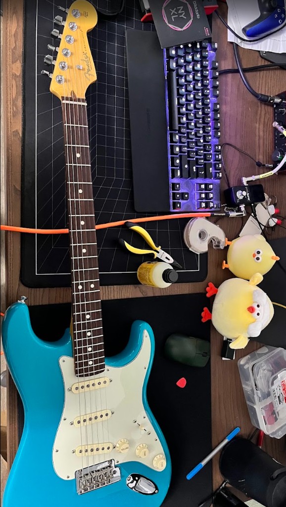 blue fender stratocaster on a desk