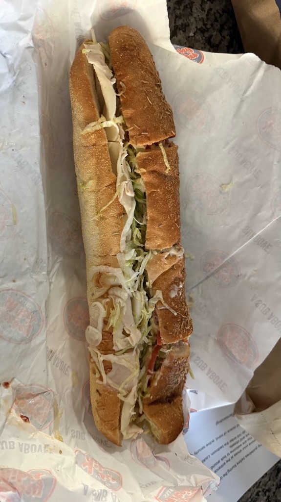 Giant turkey and provolone sub from Jersey Mike's with lettuce, tomato, and onions on a sesame roll
