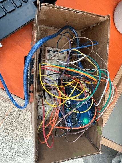 Inside the box: an Arduino and breadboard with a tangle of jumper wires